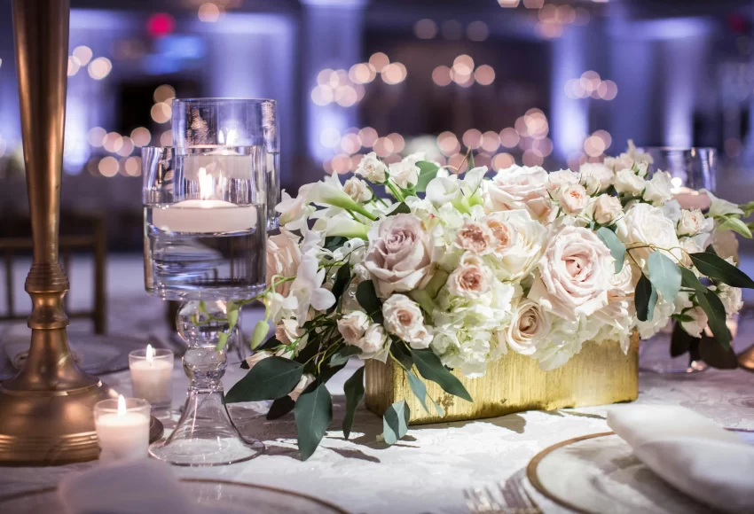 a table with flowers and candles